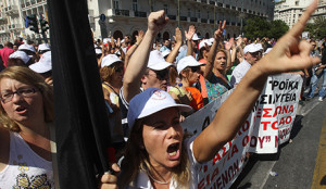 Protesters  clash with riot policemen during a  a general strike protest in AthenS