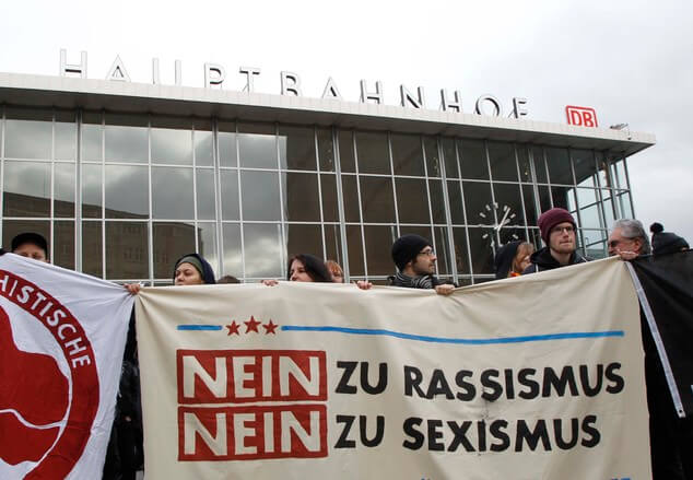 People protest in front of the main station in Cologne, Germany, on Wednesday, Jan. 6, 2016. The poster reads: 